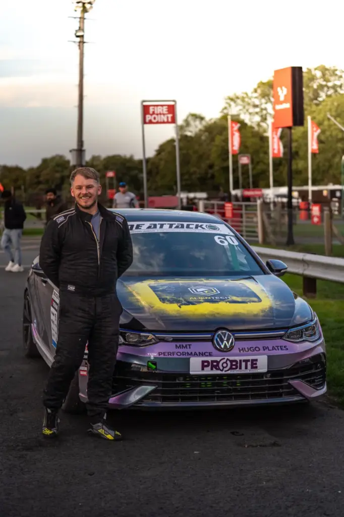MMT’s driver beside the Golf R race car in the Cadwell Park paddock